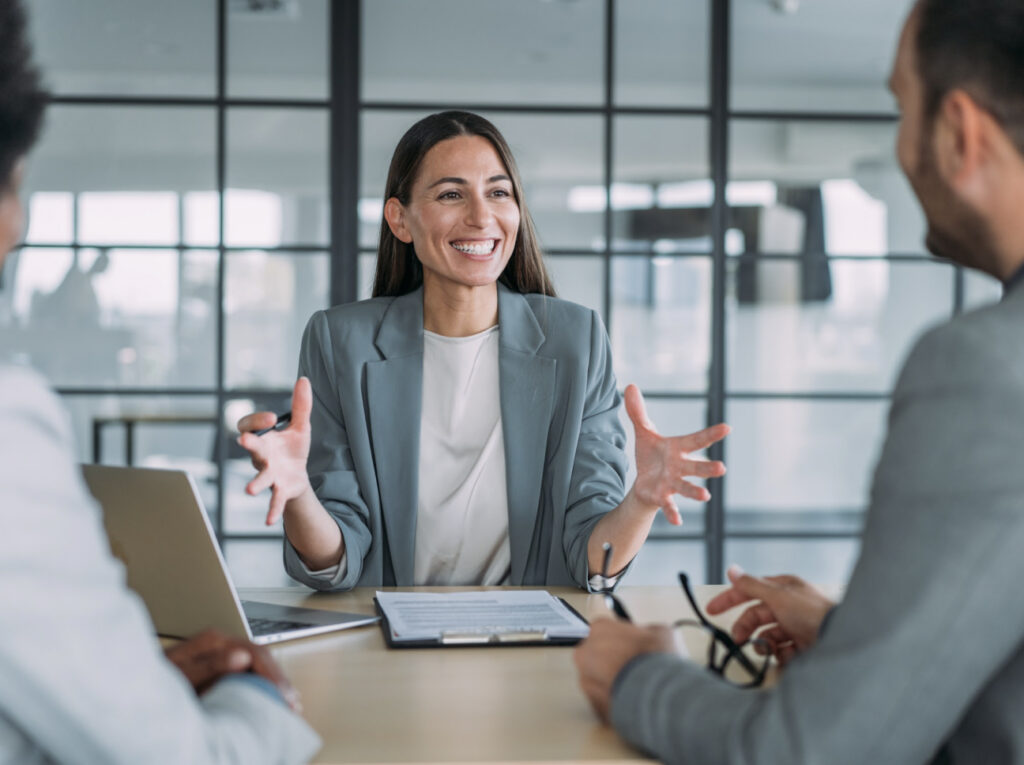 Group of business persons talking in an office.