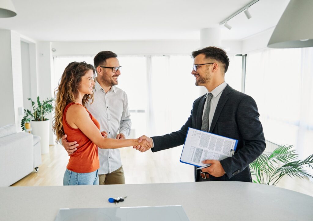 Couple signing a contract with a business agent.