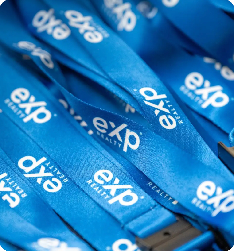 Blue lanyards with "eXp" branding.